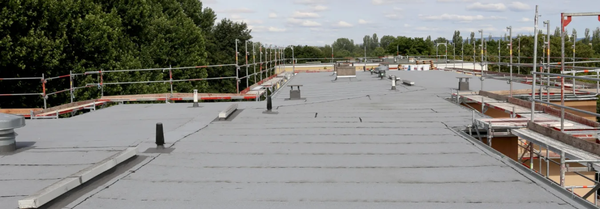 24 Top view of modified asphalt roofing on commercial building.